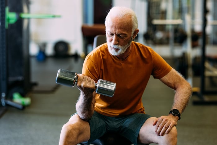 Person in the gym, lifting weights.