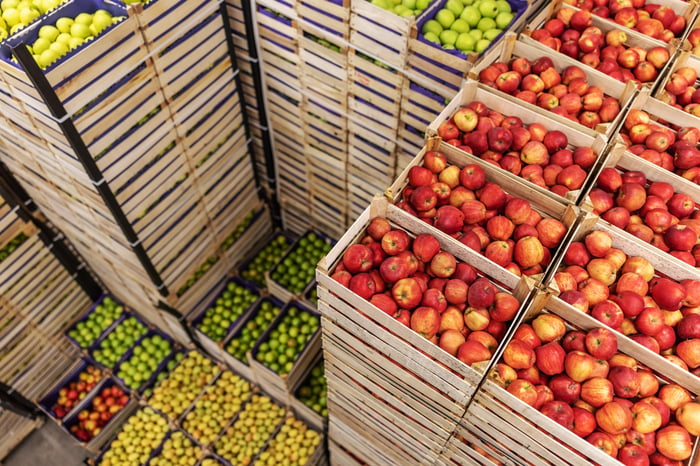 A pile of fruits and vegetables in crates. 