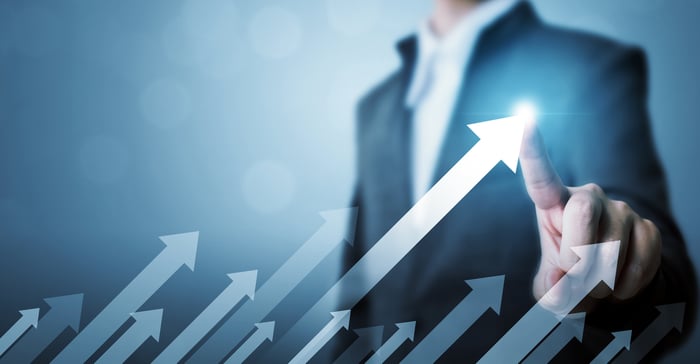 A person near several upward pointing arrows.