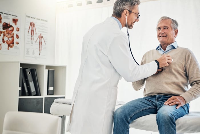 A doctor using a stethoscope.