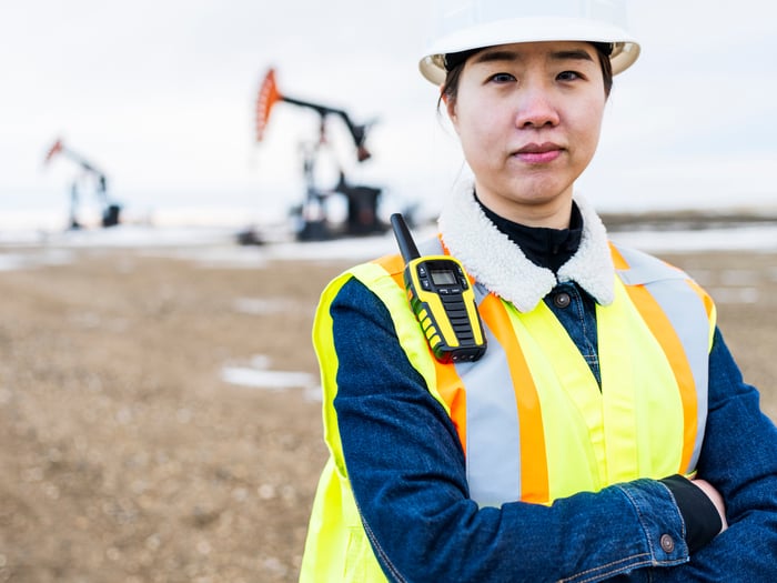An oil company worker maintains equipment.