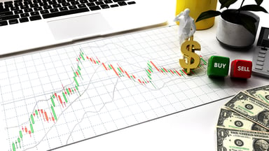 GettyImages-candlestick stock chart on a desk with laptop