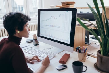 Professional_analyzing_stock_charts_on_a_desktop_monitor