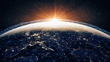 An interconnected grid covers Earth as the sun rises over the horizon, illustrating the growing importance of global connectivity.