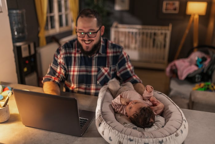 Father with a baby at a computer.