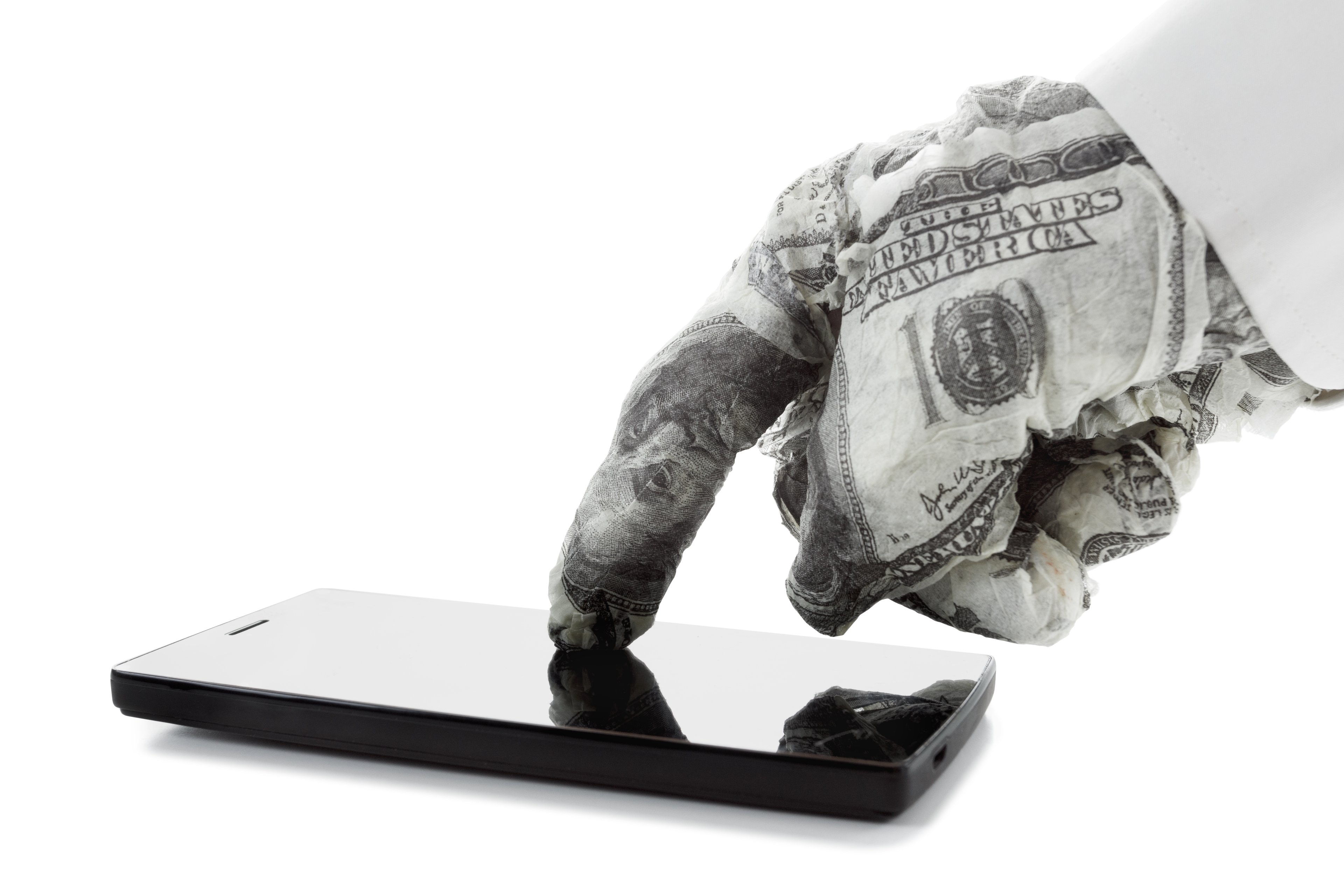 a hand wrapped in bills touches a smartphone
