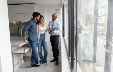 People looking at a house with a real estate agent