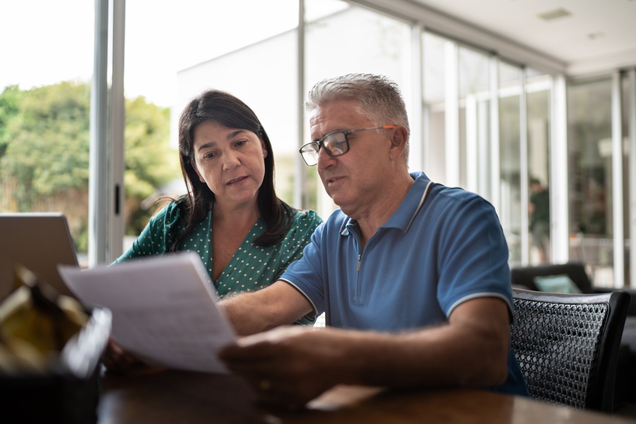 Middle aged couple looking at document