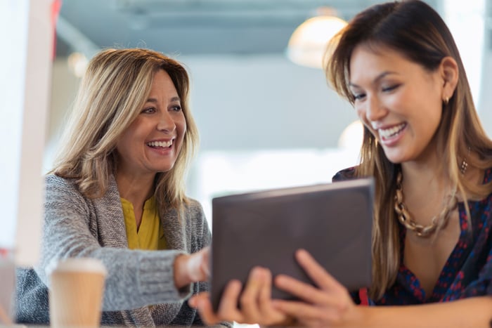Happy colleagues working with a tablet.