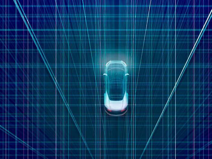 A car driving over a digital 3D environment. 