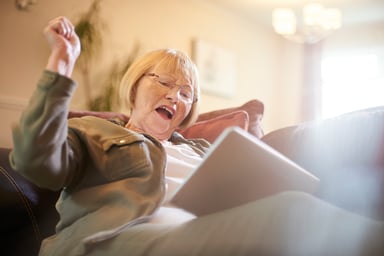 21_05_18 A person with a tablet and a look of happy surprise _GettyImages-854218734