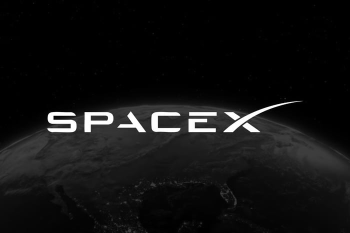 SpaceX logo against black background. 