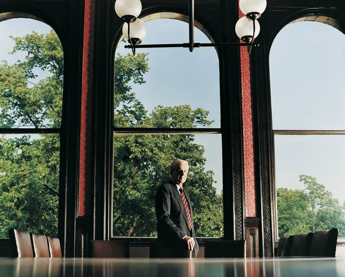 A person standing by a big window.