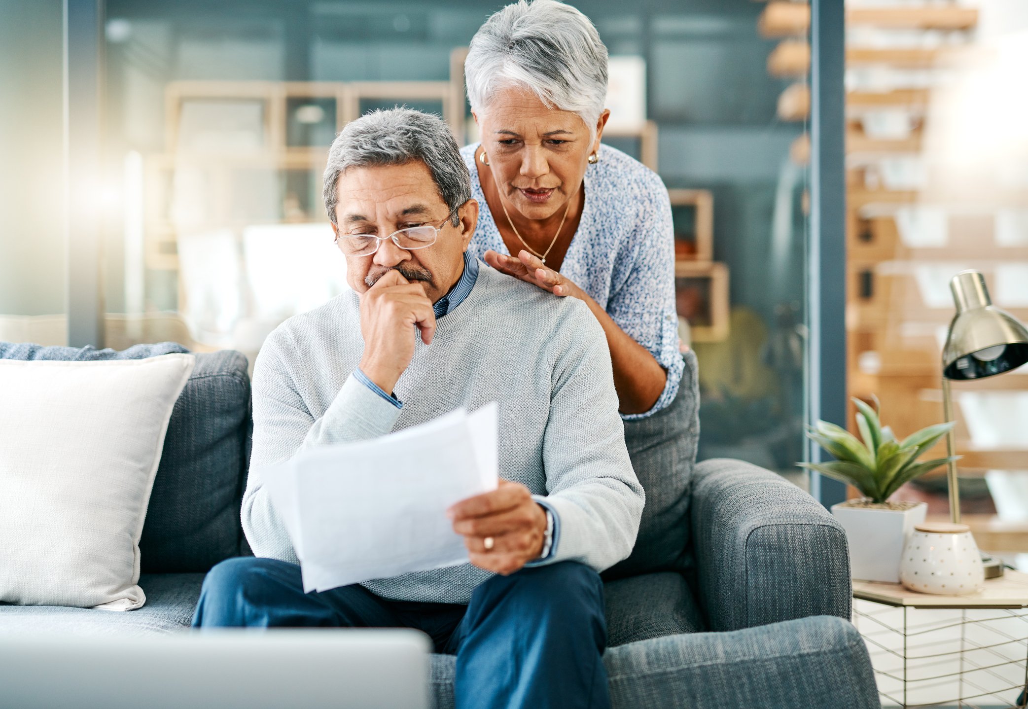 Two people looking at a document with serious expressions_GettyImages-1139792625