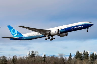 boeing 777x airplane N779XN taking off with boeing logo-BA