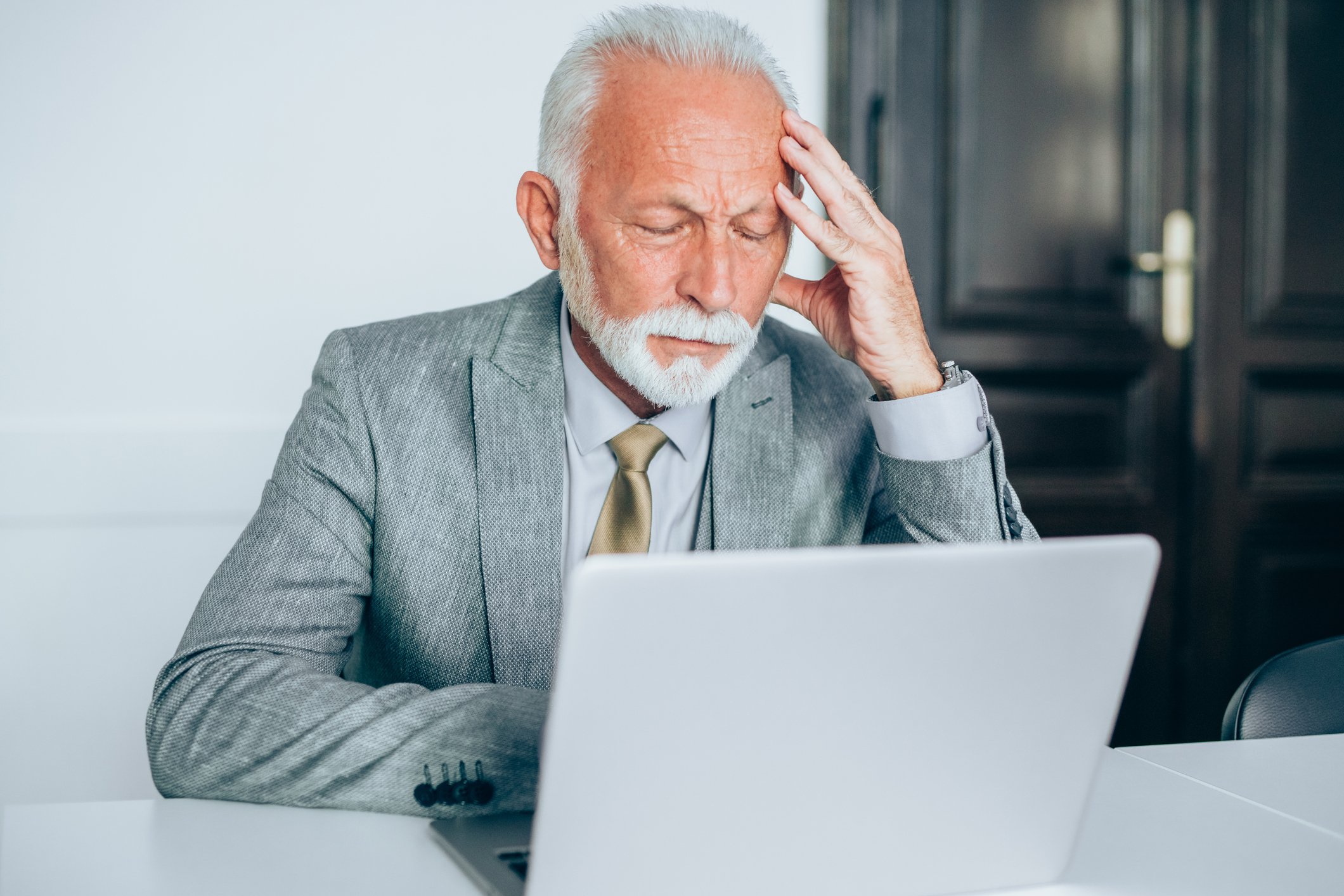 senior man suit laptop stress GettyImages-1186388803