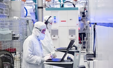 inside intel factory two people working on laptop with lab gear on_Intel