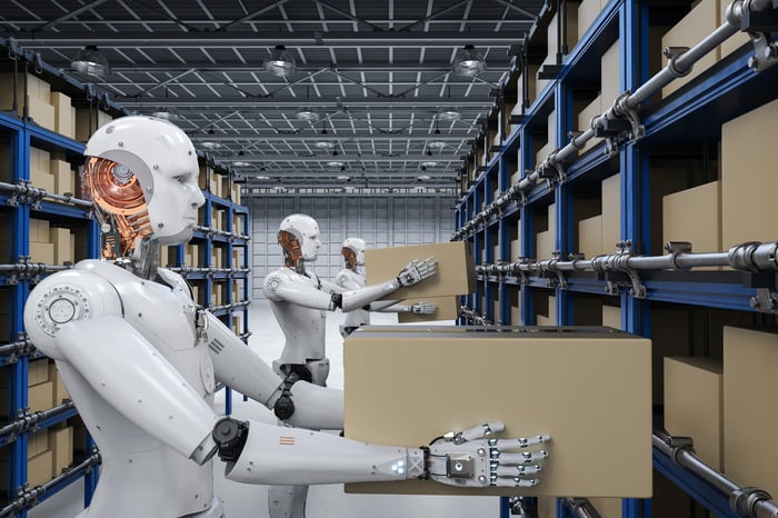 Humanoid robots working in a warehouse.