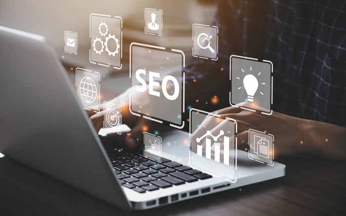 A graphic with a laptop and the letters SEO. 