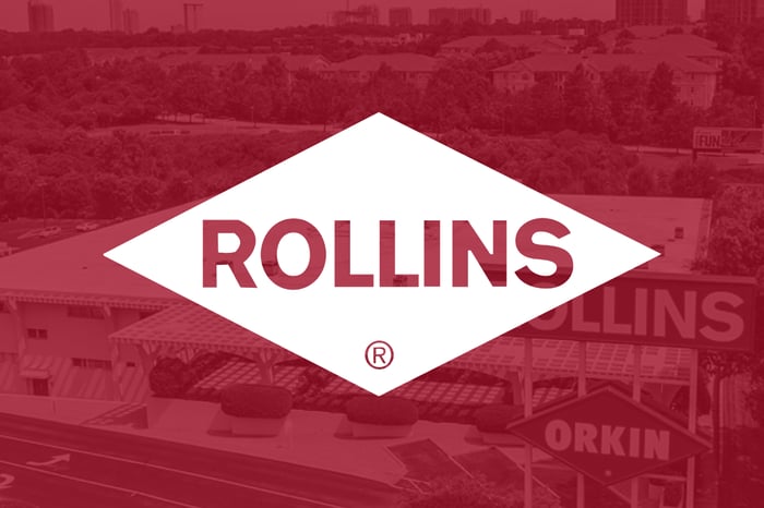 A Rollins logo sits against a red backdrop of an old-timey-looking Rollins location.