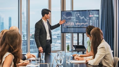 Person giving a presentation involving a stock chart.