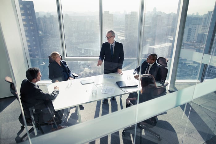 People in a board room talking.