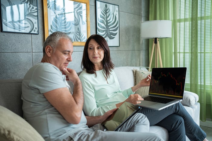 A happy couple of investors plan their future with international stock ETFs.