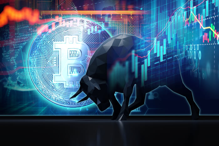 A Bitcoin logo stands behind a charging bull with a stock chart superimposed.