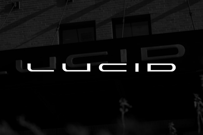 Whitel Lucid logo set over dark shaded view of Lucid  headquarters.