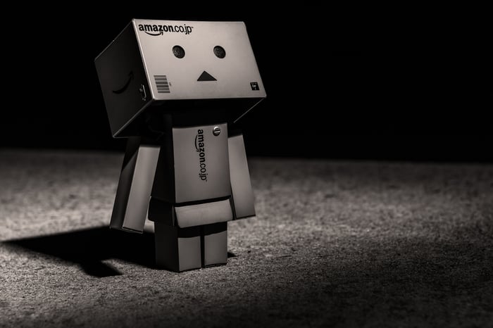 A robot made out of gray boxes with the Amazon logo.
