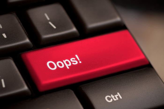 Oops! on a red key on a keyboard.