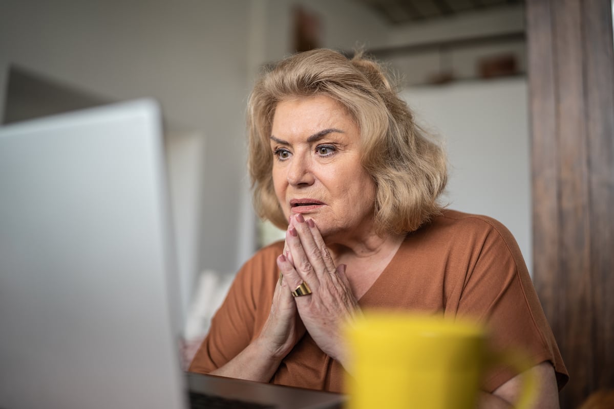 Worried person staring at laptop