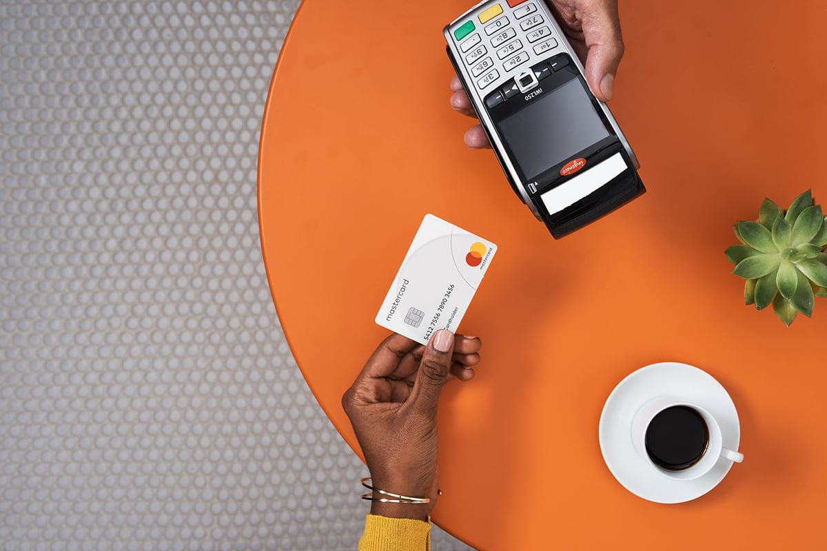 Mastercard-card-and-payment-terminal-cafe-table