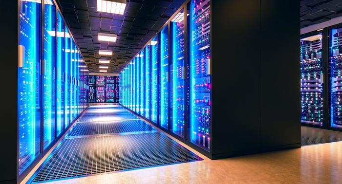Server racks glowing in a data center. 