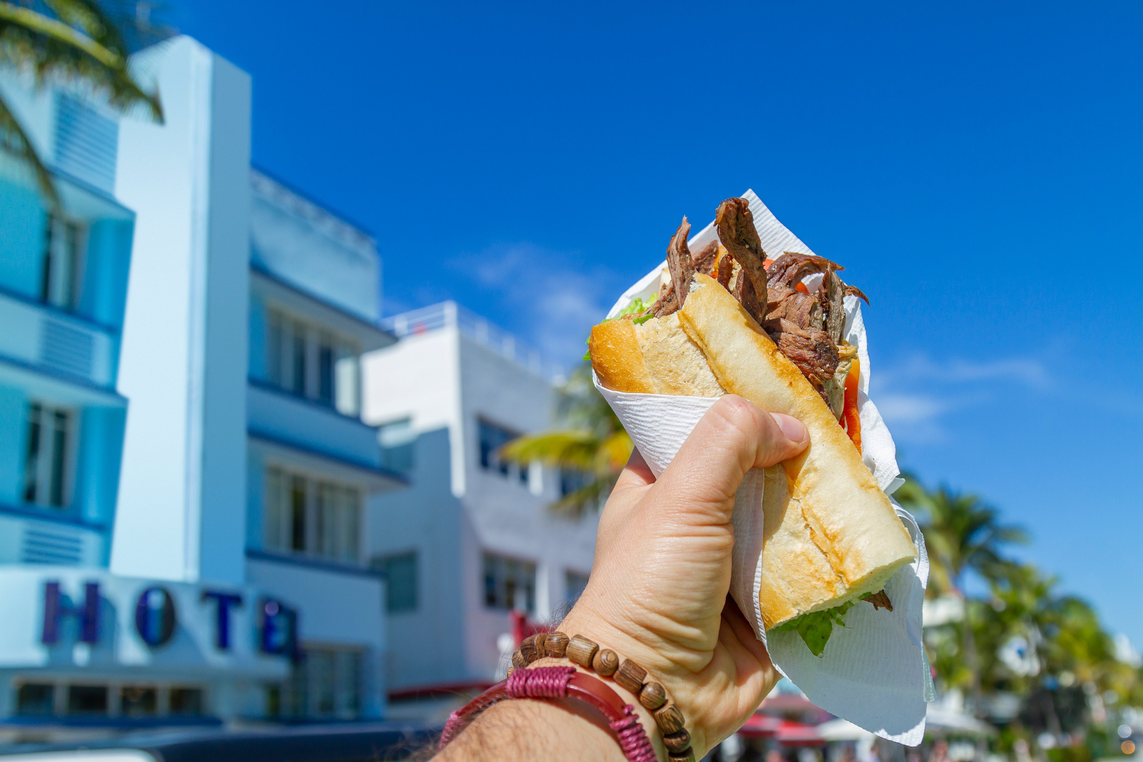 holding up a submarine sandwich