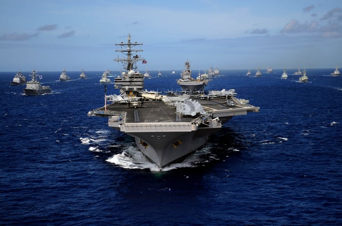 A U.S. Navy aircraft carrier is sailing with its escort ships. 