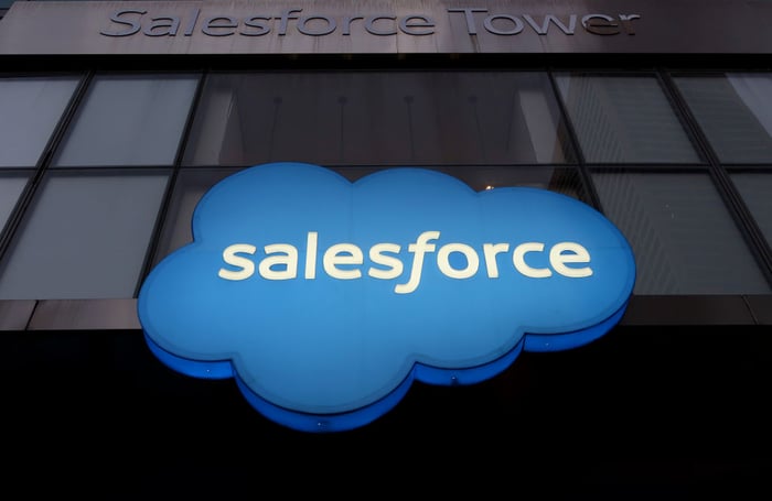 The Salesforce corporate logo in the shape of a blue cloud displayed at the entrance of an office building.