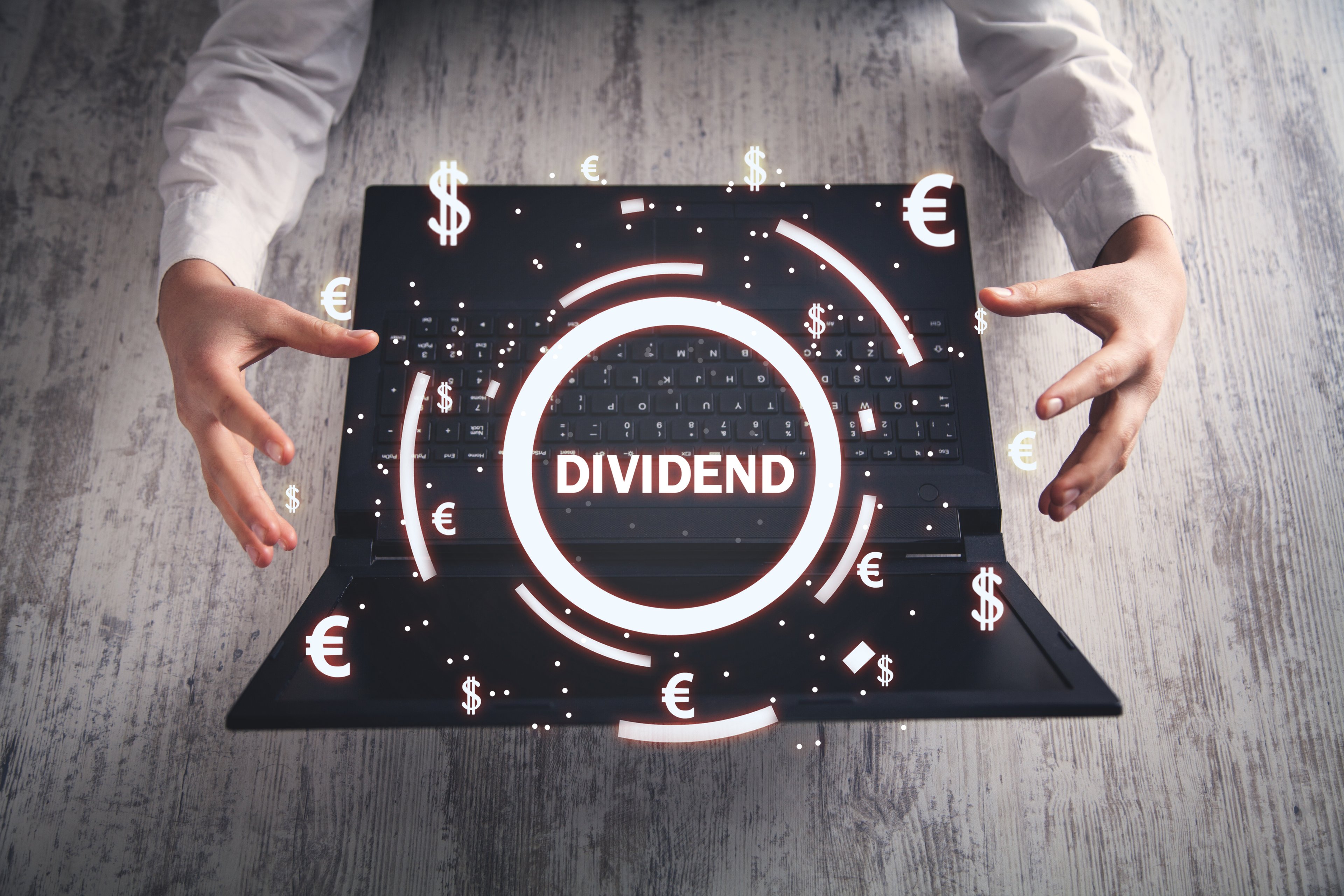 dividend-circle-laptop-currency-symbols-getty