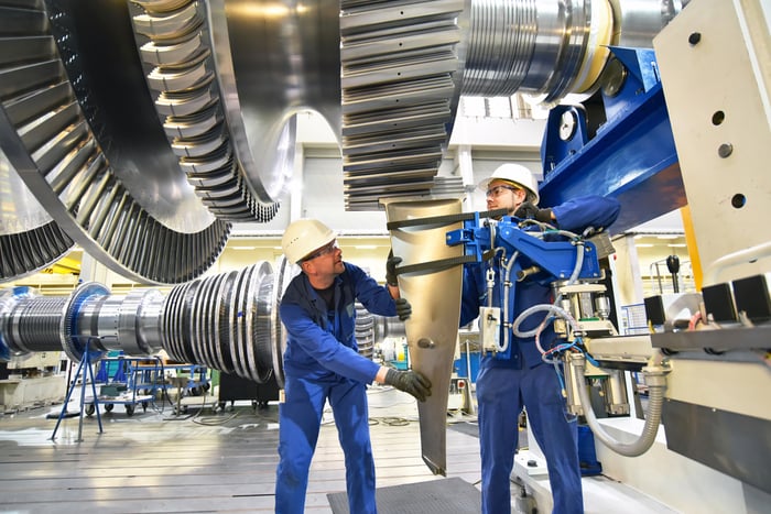 Two engineers working on a jet engine.