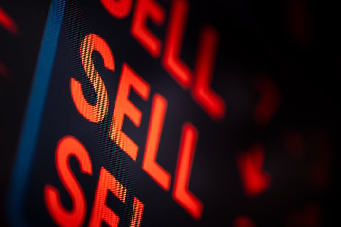 An illuminated sign reading "Sell sell sell" in red letters.