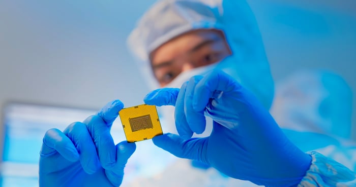 Technician holds microchip.