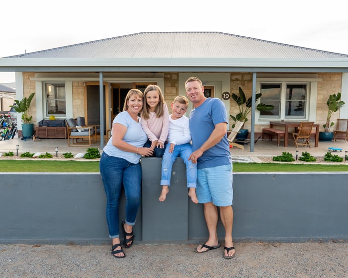 A family in front of a home.