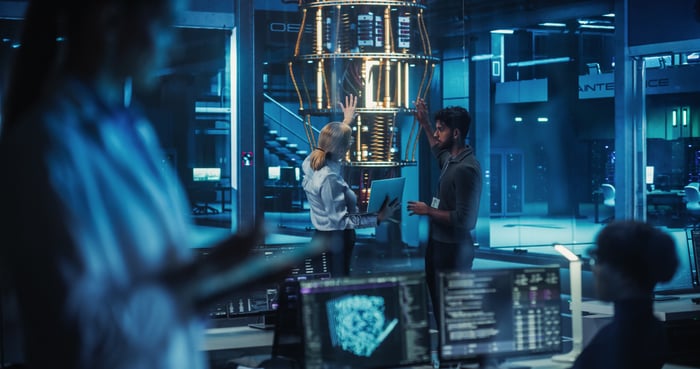 People standing around a computer.