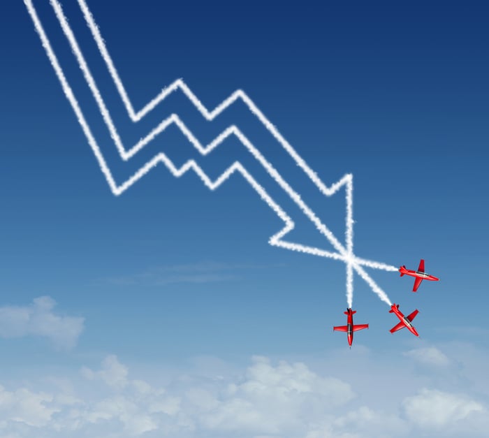 3 red airplanes leaving contrails pointing down.