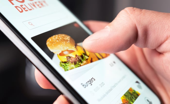 Someone ordering a burger on their phone. 