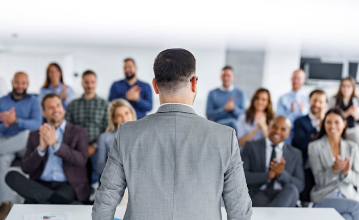 An executive speaking at a company meeting.