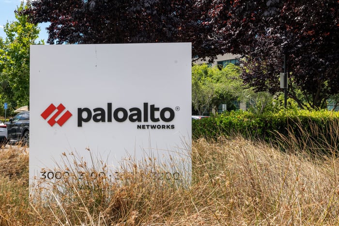 A Palo Alto Networks logo on a sign in a field.