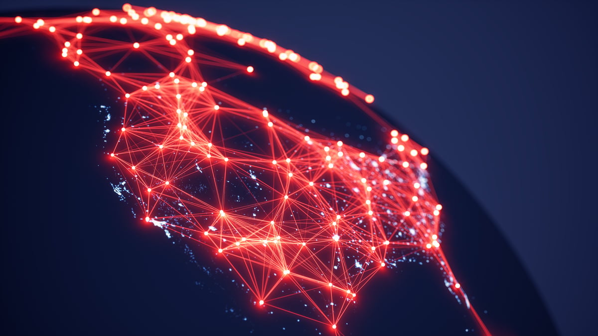 Interconnected beams and dots of red light cover North America, illustrating the importance of digital communications in the modern economy.