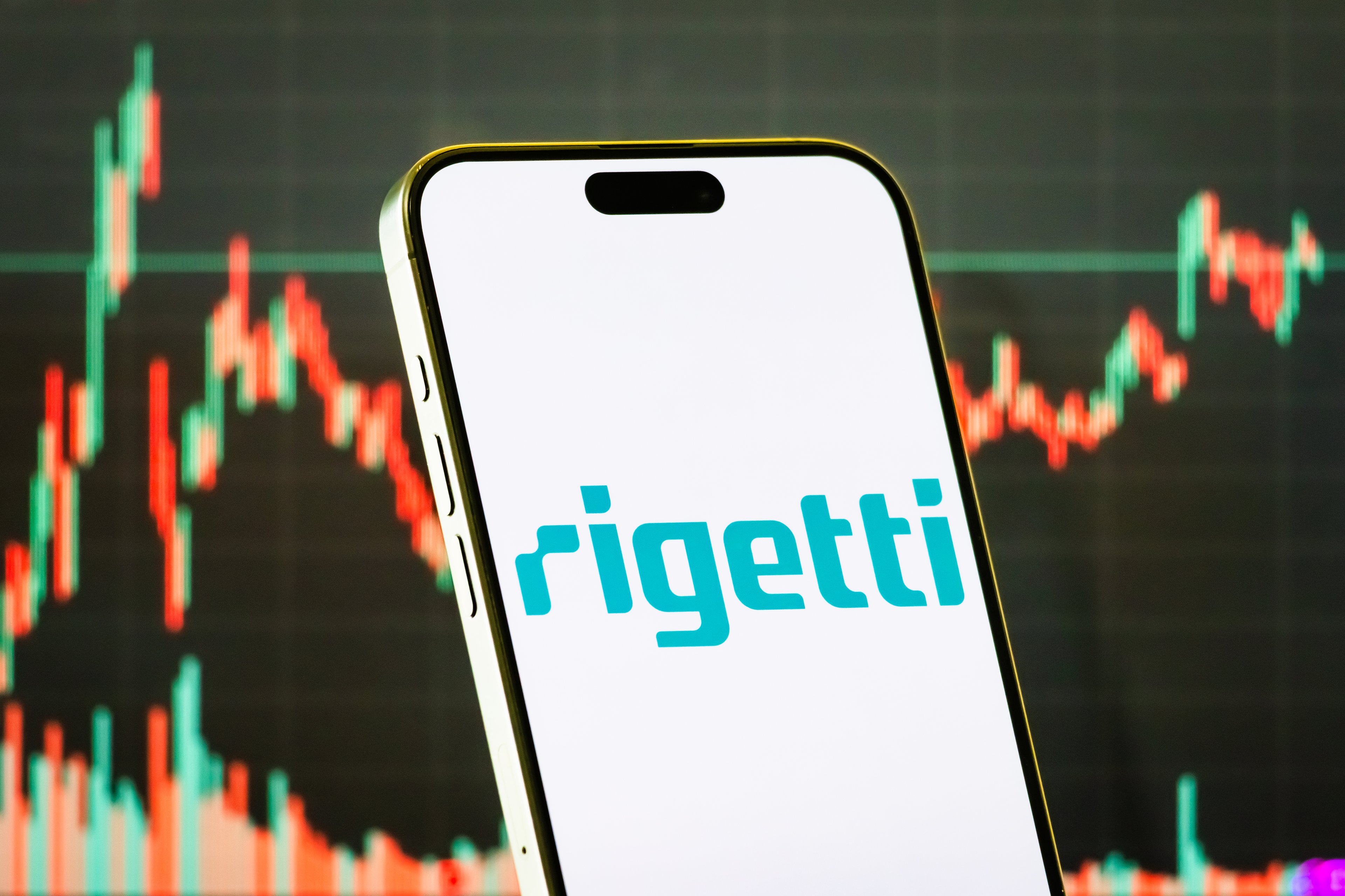 rigetti logo on smartphone with stock chart background-RGTI