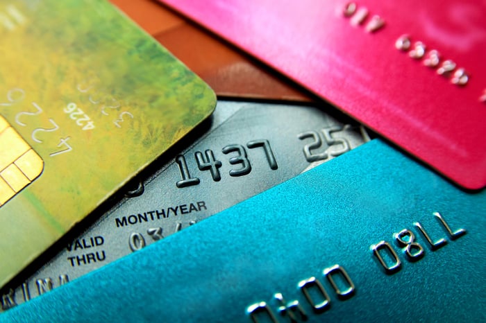 Jumbled pile of credit cards of multiple colors.
